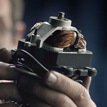 Person looking at blender motor closely