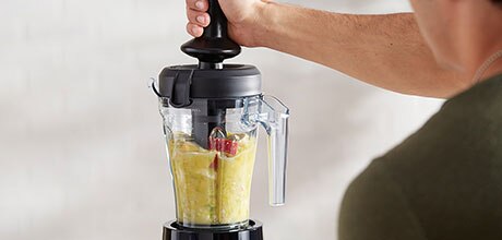 Person using the tamper in the 40 ounce container
