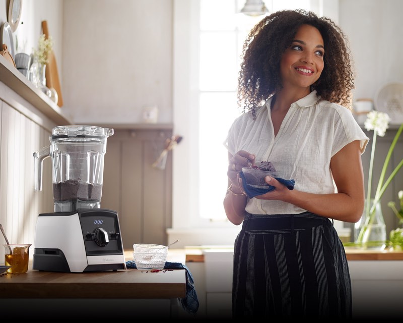 Woman in room with Vitamix machine making dessert