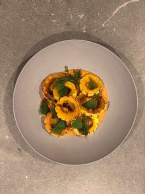 Bowl of cooked squash with herbs